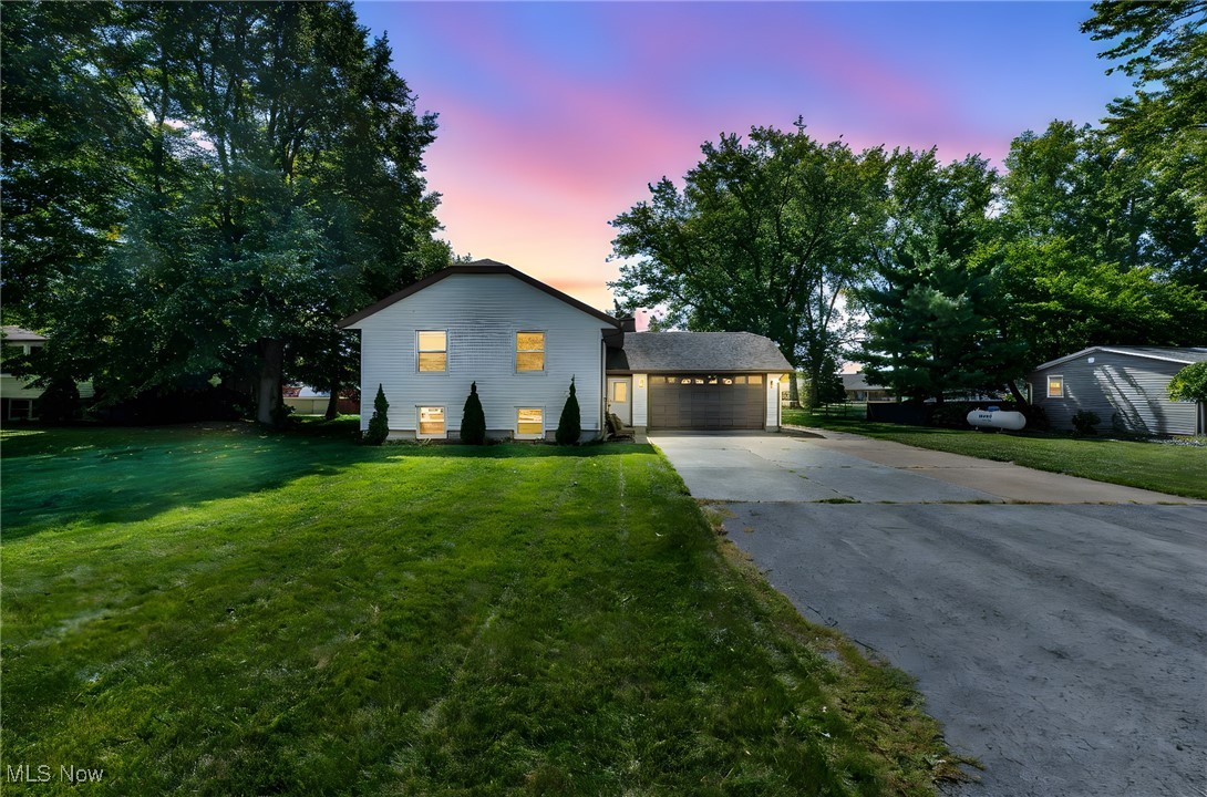 Welcome to 5704 McCartney Road, a beautifully maintained split-level residence located in the desirable Cold Creek Acres subdivision of Sandusky. Offering 4 bedrooms, 2 full baths, and over 2,200 square feet of finished living space, this home provides both comfort and functionality. Situated on nearly a half acre with a 100x200 lot, the property combines spacious interiors with inviting outdoor features perfect for gatherings, entertaining, and enjoying the proximity to Lake Erie. The main floor greets you with a bright entrance foyer and flows into a large family room highlighted by a cozy fireplace. A formal dining room with bamboo wood flooring and a spacious eat-in kitchen with ceramic tile, laminate counters, and plenty of cabinetry create the heart of the home. Three bedrooms and a full bath are conveniently located on this level. The lower level offers even more living flexibility with a recreation room with a second fireplace, an oversized fourth bedroom with walk-in closet, full bath, laundry area, and utility room, plus a bonus space that could easily serve as a guest suite or private living quarters. Outdoors, enjoy permanent horseshoe pits, a cement fire pit with built-in seating, and a landscaped backyard ideal for entertaining. The home is just a short 5–10 minute walk to the lake, making it a prime location for those who appreciate outdoor living. Updates include efficient HVAC, newer energy-efficient appliances, lighting, and four ceiling fans along with an attic fan set to be replaced in September 2025. Additional features include central air, forced air gas heating, an attached two-car garage with opener, concrete driveway, patio, and block foundation with full finished basement. Sandusky City School District, curbs, sidewalks, and streetlights add convenience. Taxes are affordable at $2,771 (2024). Seller offering a $5,000 carpet credit at closing and requests 14 days possession after close. This move-in ready home is available for a quick sale!!