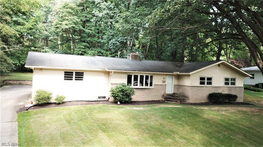 Spectacular find in Tallmadge! This well maintained 3 bedroom ranch sits on a large private lot, and on a quiet street. Wooded backyard features a pavilion, creating a true park like setting. Other great features worth noting include: beautiful hardwood flooring, high- quality vinyl replacement windows throughout the home,  spacious bedrooms, kitchen soon to be with brand new stovetop and refrigerator. Finished basement with bright oversized laundry room. 2 car rear facing attached garage. So much to love about this one! Don't miss out on this great opportunity. Call today for your private tour