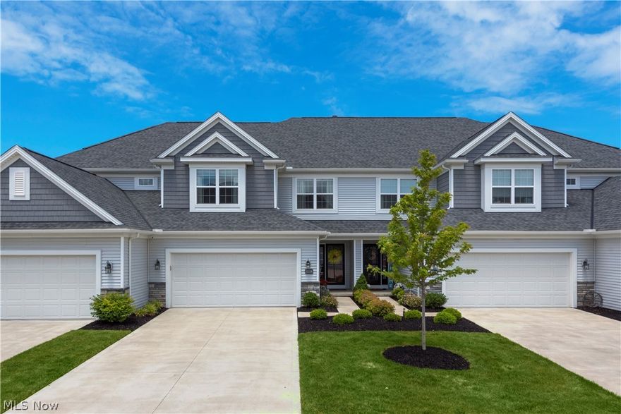 Welcome home to Arrington Village Townhomes, a maintenance free community nestled between the tranquil green space of Weiss Field and the Historic Klingshirn Winery of Avon Lake. This spacious and absolutely move in ready home features thoughtful upgrades throughout!  Enter into the large foyer that leads to an open floor plan with impressive cathedral ceilings, wide plank hard wood flooring and a wall of windows which cascade the first floor with natural light. The beautiful great room has a cozy corner fireplace, a large dining area and an upgraded kitchen with a breakfast bar making this open concept floor plan perfect for any lifestyle. As you make your way up the wood staircase to the second floor, you will find the owners suite and two additional bedrooms. The owners suite presents high ceilings a cozy window seat and an opulent ensuite with quartz counters a double vanity and 2 walk in closets. The two additional bedrooms are both of a generous size and share a full additional b