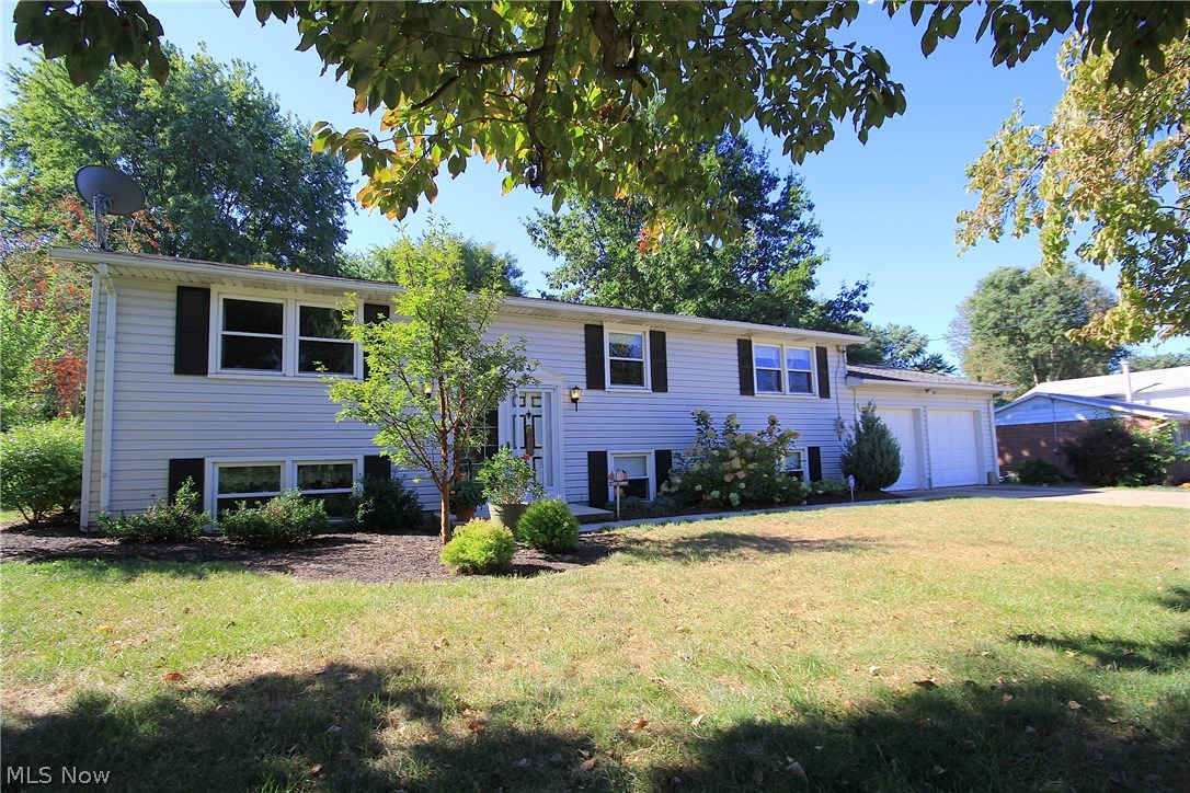 Beautiful 3 bedroom, 1.5 bath Bi-level with large open living spaces! Recently remodeled kitchen with new flooring, countertops, sink and backsplash. Patio door from Kitchen leads to large deck overlooking private backyard with mature trees and huge 20x14 Amish built barn. Gorgeous main bath has been updated with wood laminate flooring. Open living room with new carpet and 3 spacious bedrooms complete the main level. Lower level has 2 huge rooms to use as a recreation room or additional living space. There is a oversized 2 car garage with large mud room upon entryway. Additional updates include New Water Filtration System, Air Conditioner, and Attic Insulation. This home has been beautifully decorated and move in ready so make it a must see today!