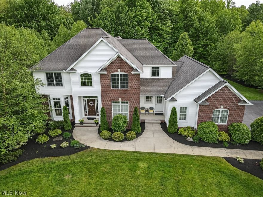 This amazing home is meticulously crafted. As you enter into the 2-story foyer, the rich Brazilian cherry hardwood floors will embrace you. You will flow through the open floor plan to the cathedral-height great room, w/gas fireplace and custom woodwork. The window wall showcases the elegant grounds, bringing the outdoors inside.The kitchen has KraftMaid cabinets with custom end panels, stylish hardware/doors, under-counter lighting, and newer stainless appliances. The 1st floor includes a formal dining room w/wainscoting, living room and a bonus room you can use as an office or a bedroom. The spacious master ste, with tray ceiling and custom molding, adjoins a master bath w/granite counters, private tub and shower. There is an upscale bathroom on the second level shared by the large bedrooms that are spacious w/large closets. The lower level can be used by guests or as a media room with a 3rd bathroom. The home includes a 360-degree wireless Dolby Atmos sound system. The private backy