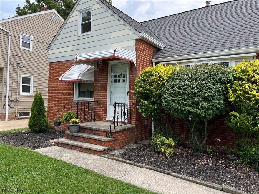 Classic, move-in ready, adorable brick bungalow with coved ceilings, bay window, and fabulous hardwood floors. The
kitchen is updated with stainless steel appliances, matte black hardware and faucet, new flooring, and freshly painted
white cabinets. 2 main level bedrooms and a 3rd huge bedroom on the second floor with tons of storage, a cedar closet, and new carpet.  A partially finished basement featuring a custom vintage bar and chairs, freshly steamed carpet and clean utility area with matching washer and dryer. Additional parking pad or patio. Roof 2020. Freshly painted and updated lighting. Close to shopping, parks, playground, and Lake Erie
