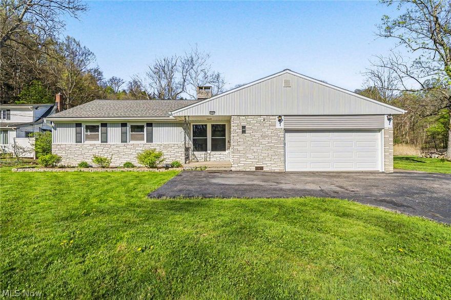 Welcome home to this beautifully updated property nestled on a serene wooded lot in the heart of Willoughby Hills. This charming home offers modern comfort, thoughtful updates, and inviting spaces throughout. Major improvements include brand-new windows, a new roof (2016), hot water tank (2018), and a furnace less than 10 years old, providing peace of mind for years to come. Step inside to discover a brand-new, massive kitchen designed for both functionality and style—complete with all new stainless steel appliances, abundant counter space, and a bright, open feel. Just off the kitchen, you’ll find a spacious mudroom paired with a separate walk-in pantry, offering exceptional storage and everyday convenience. Enjoy two inviting living spaces that share a stunning two-sided fireplace, perfect for cozy evenings or entertaining guests. Off the back of the home, step out onto the brand-new 10x20 deck where you can relax and soak in the tranquil views of the private, wooded backyard. This home features three generously sized bedrooms,
including a comfortable primary suite with its own en-suite bathroom. Guests will appreciate the additional full-sized bath
conveniently located near the secondary bedrooms. Additional highlights include an attached two-car garage and a spacious attic, ideal for extra storage. Move-in ready and surrounded by nature, this home offers the perfect balance of modern updates and everyday comfort. Don’t miss your chance to make this peaceful retreat yours!