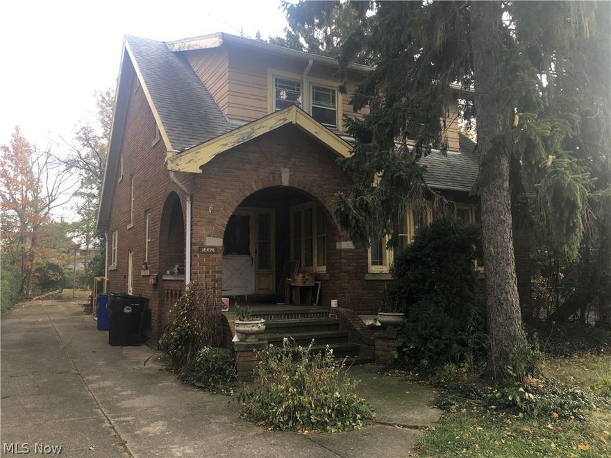 This remarkable home is just waiting for you! Brick exterior, newer roof and boiler, rare masonry 2-car garage, a deep, wooded lot, and a location that is close to everything! You will love some of the interior features - eat-in kitchen, gracious dining room overlooking the back yard, spacious living room - hardwood floors and much original woodwork! Upstairs are three bedrooms (one with additional sunrooom), and a vintage full bath. Lower level has a finished area perfect for movie night, workout area, or simply a place to relax. A bit of work and this will be your "forever" home! Close to parks, Lake Erie, shopping, transportation, medical, cool independent E. 185th St. Eateries,Waterloo Arts District, and just 15 minutes from downtown! See it today!