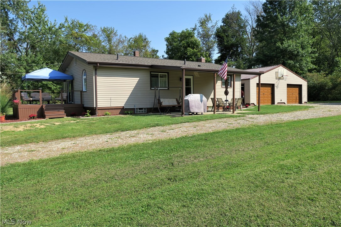 Beautifully updated and well kept 2 bedroom, 2 full bath ranch with first floor laundry! Oversized 30x30 garage with a workbench, newer metal roof, floor and decorative garage doors! You'll enjoy this gorgeous kitchen, featuring beautiful hickory cabinets, newer laminate flooring, breakfast bar and pantry. Gather in the spacious living room with French doors that lead out to the front deck! The newly updated main floor bath features a tile shower surround and new cabinets for additional storage. Across the hall from the master bedroom is where you'll find your first floor laundry with a door leading to the back deck. The very clean, waterproofed full basement provides for extra storage and can easily be converted to additional living space and features a 2nd spacious full bathroom. Lots of outdoor spaces to enjoy the various seasons, including the front and back decks and a large covered patio. Extras include: New aeration septic system in June 2019, new water filtration system, new ro