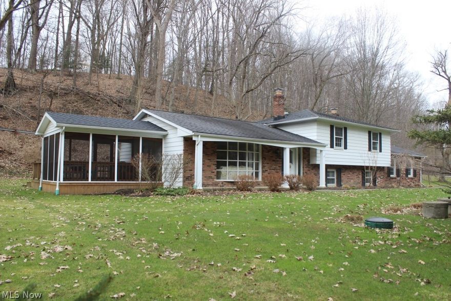 Darling 3 bedroom, 2.5 bath split nestled on a sprawling 1 acre plush lot. Formal living with bay window overlooks gorgeous front yard. Formal dining room. Amazing '11 addition of a screened in sun porch w/ access to exterior deck w/ built in gas grill. Eat in kitchen w/ stainless steel appliance, great storage & another  bay window. Walk out lower level family room w/ wood burning fireplace and new flooring. Master bedroom w/ hardwood floors, 3 closets & master bath! 2 additional bedrooms w/ hardwood floors and another updated '10 full bath w/ granite off main hall. Access off family room to enormous laundry room with walls of storage. 2 car attached garage. Amazing views of this country setting w/in the city. Won't last long! Beautifully taken care of!