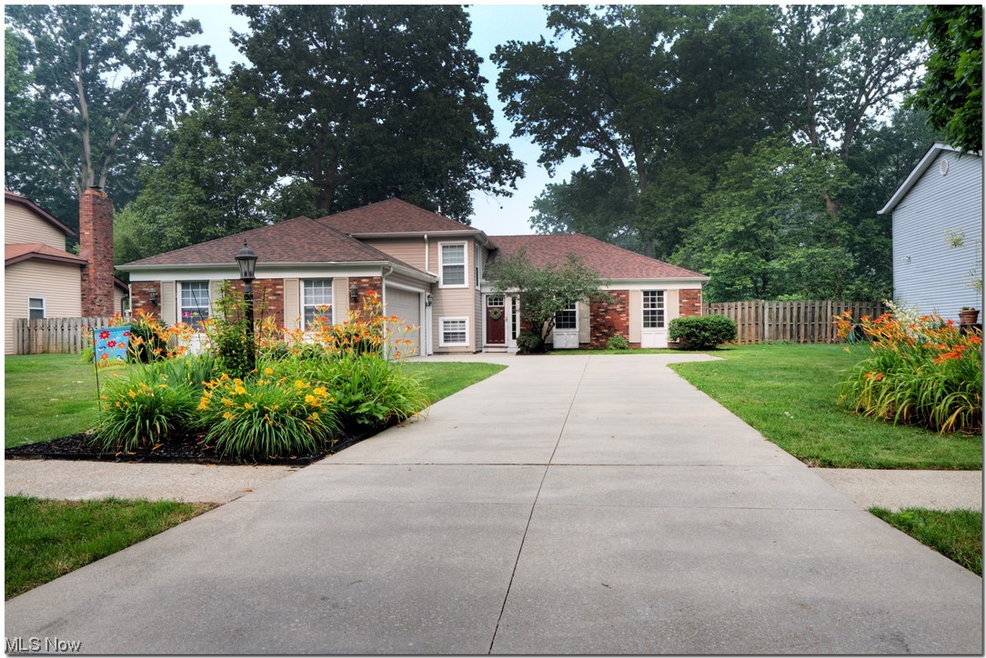 You'll have plenty of room in this oversized split with side entry garage and spacious fenced back yard and deck. The classic main level features living and dining rooms plus a foyer with engineered hardwood flooring taking you into an eat-in kitchen with Maple cabinetry and a pantry. Kitchen appliances, including refrigerator, gas range, and dishwasher stay. A few steps down take you to a generous family room with brick wood burning fireplace and LVT flooring (2018). The half bath and lower level bedroom (closet in hall) and laundry/mudroom are nearby. Washer and gas dryer stay. On the upper level, the master suite has newer carpet and includes a sitting, room, walk-in closet, and private full remodeled bath. Another full bath and two more bedrooms complete that level. The roof was replaced in late 2017 along with gutters and gutter guards in 2018. The vinyl siding was installed in 2022. The garage offers storage above. Additional attic storage is accessed from the northwest bed