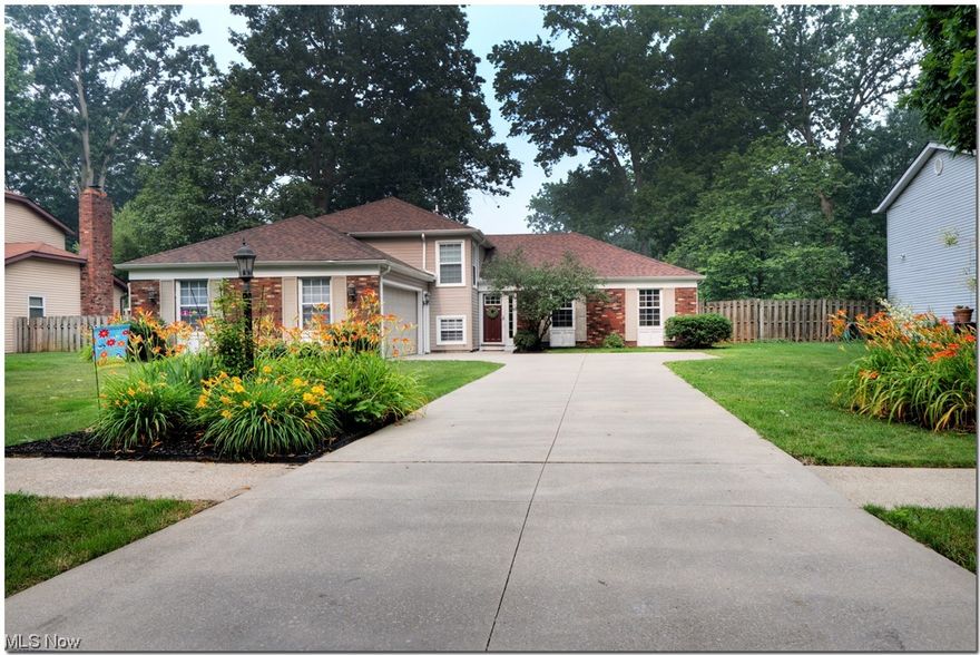 You'll have plenty of room in this oversized split with side entry garage and spacious fenced back yard and deck.  The classic main level features living and dining rooms plus a foyer with engineered hardwood flooring taking you into an eat-in kitchen with Maple cabinetry and a pantry. Kitchen appliances, including refrigerator, gas range, and dishwasher stay.  A few steps down take you to a generous family room with brick wood burning fireplace and LVT flooring (2018). The half bath and lower level bedroom (closet in hall) and laundry/mudroom are nearby. Washer and gas dryer stay. On the upper level, the master suite has newer carpet and includes a sitting, room, walk-in closet, and private full remodeled bath. Another full bath and two more bedrooms complete that level.  The roof was replaced in late 2017 along with gutters and gutter guards in 2018.  The vinyl siding was installed in 2022.  The garage offers storage above. Additional attic storage is accessed  from the northwest bed