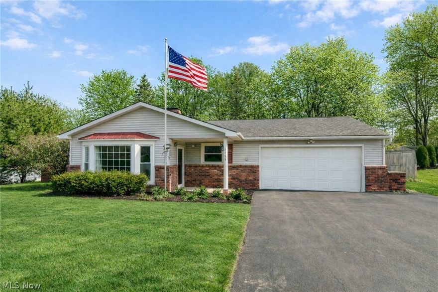 Welcome to 7755 Fairlawn Drive in desirable South Mentor, a true ranch offering convenient one-floor living on a beautifully sized half-acre wooded home site. An extra-wide driveway leads to the attached two-car garage and provides abundant parking for guests. Inside, the open and inviting layout features a main living room highlighted by a striking sandstone, wood-burning fireplace that serves as the centerpiece of the home. The living space flows seamlessly into the formal dining area and an updated kitchen appointed with classic oak cabinetry, ample counter space, and a bright breakfast area perfect for casual meals. A spacious rear family room showcases soaring vaulted ceilings and skylights that fill the space with natural light while offering serene views of the private backyard. Step outside to the deck overlooking the expansive lot, ideal for entertaining, gardening, or simply enjoying the peaceful wooded setting. The home offers three comfortable bedrooms, one full bath, and a convenient half bath, along with a dedicated first-floor laundry room for added functionality. Dual storage sheds provide excellent space for tools and outdoor equipment. With its thoughtful layout, scenic setting, and sought-after ranch design, this home delivers comfort, privacy, and everyday practicality in a prime South Mentor location close to parks, shopping, and the Lake Erie shoreline. Enjoy peaceful mornings on the deck, evenings by the fire, and the ease of single-level living designed for both everyday comfort and effortless entertaining, all within a quiet neighborhood setting known for its spacious parcels and mature trees. Situated on a generous half-acre lot, the property offers room to expand outdoor living areas, create garden beds, or add play space while maintaining exceptional privacy and a tranquil backdrop that enhances the overall sense of retreat.