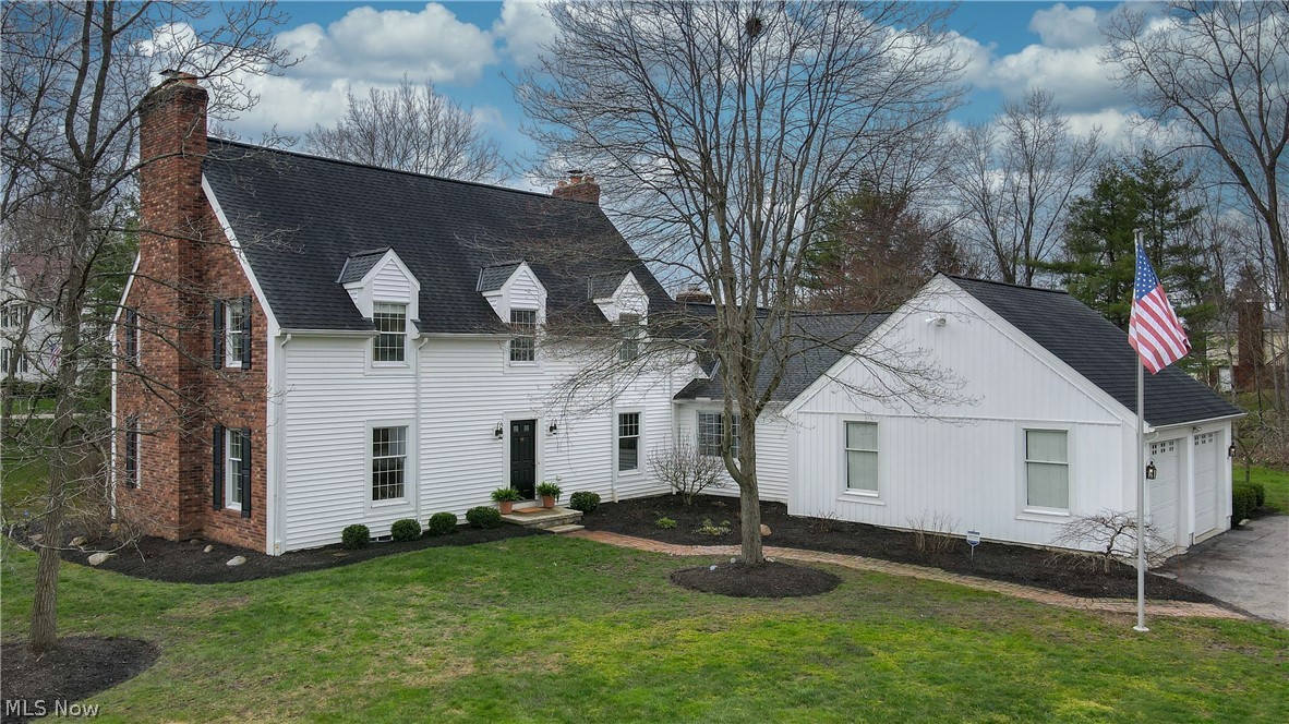 In the award winning Hudson school district, this reimagined Western Reserve Colonial features high ceilings, bright spaces and updated features throughout. The entryway opens into a large living room with wood burning fireplace, nice millwork and beautiful hardwood floors. A private office with original built-ins and grass cloth walls provides an excellent work from home space. A light filled walkway opens into the private formal dining room with beautiful wood burning fireplace + stone surround, updated center light fixture and bay windows looking out onto the exterior. The oversized great room includes lots of windows & natural light, wood burning fireplace, stylish white built-ins and access to the outside deck through french doors. Massive cook’s kitchen includes stainless steel appliances, prep counter & sink, private pantry and loads of storage. The eat-in kitchen looks to the outside through huge bay windows and includes updated light fixtures. A large main floor laundry room w