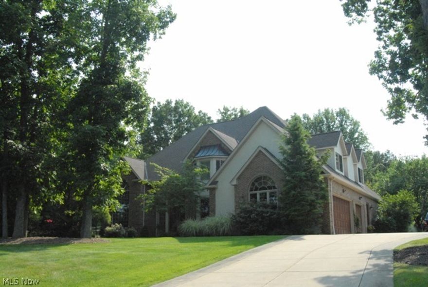 Excellent location! walking distance to village, pool, tennis courts, library, Rec center and schools. Only 12 minutes to downtown. Quiet, private upscale neighborhood, park like lot just under 1 acre. Custom built beautiful brick/stucco. Granite kitchen with new stainless appliances, 2 story great room, 2 story office, vaulted sun room, over sized dining room with built in granite buffet. Large master suite with custom granite shower and bath. 3 Bedrooms upstairs each has large closet with own private bathroom, additional loft/5th bedroom possible. Finished basement with additional bathroom, gym and guestroom.