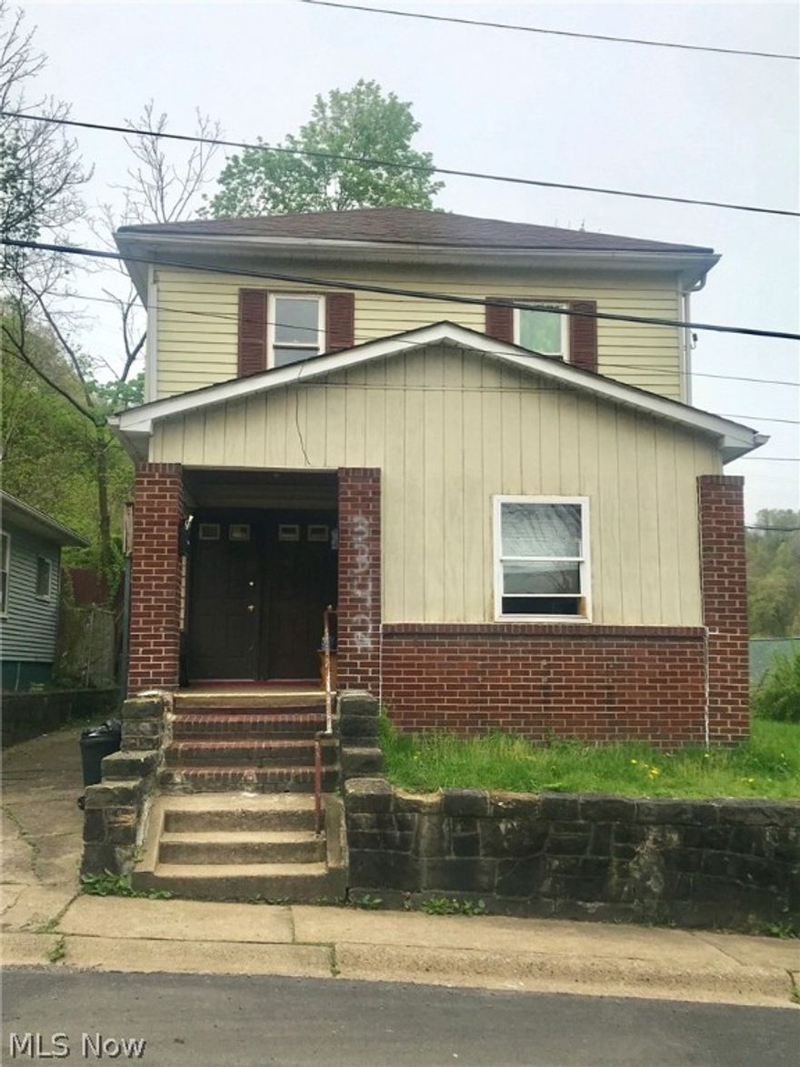 Two unit rental building with 3 BR, 1 BA in one unit and 2 BR, 1 BA in the other. Owner says annual rental income is 8880.