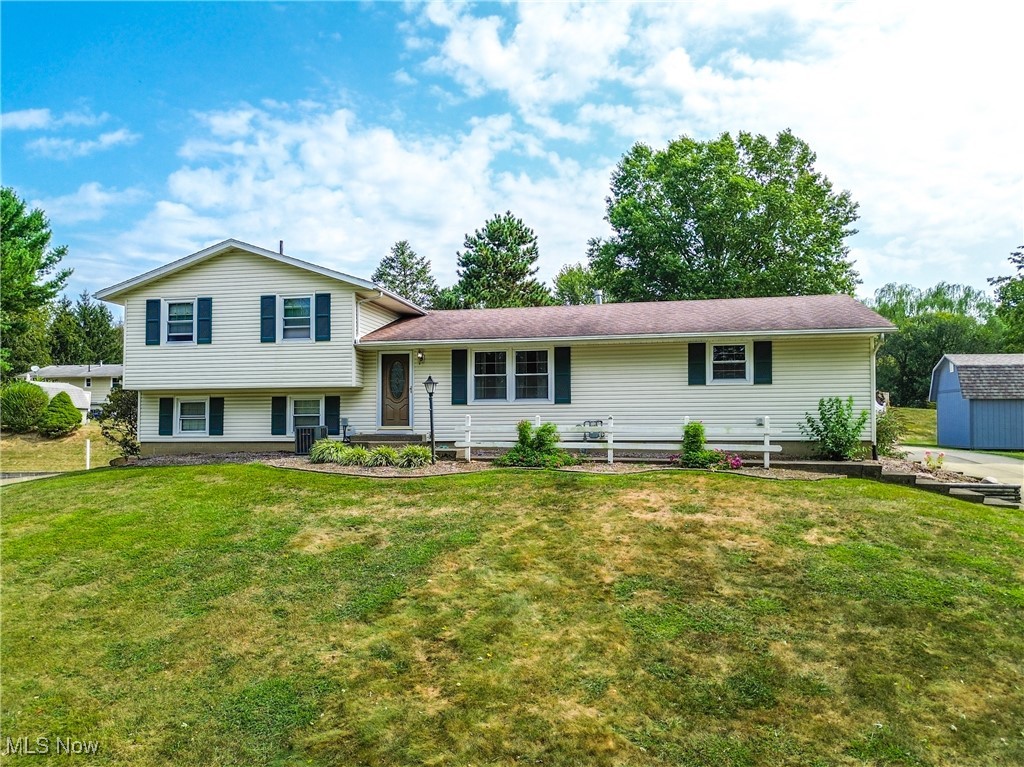 Beautiful Four-Level Split in Canal Fulton! Tucked away on a private cul-de-sac, this well-cared-for four-level split offers three comfortable bedrooms along with two full baths. The main level features newer laminate flooring and a light-filled living room. Open to the living room is the dining area with access to the patio. The kitchen is designed with painted cabinets and laminate counters. Upstairs, the remodeled bathroom includes a granite-top vanity, tiled floor, and a tiled shower with bench seating. There are three bedrooms with ample closet space. A brick wood-burning fireplace anchors the cozy lower-level family room, offering direct access to a private concrete patio—perfect for outdoor gatherings. A versatile flex space with wood paneling and an additional full bath completes this level. Practicality meets convenience with a three-car garage, one bay currently used as a workshop, and a breezeway featuring pine walls and sliding doors that connect the garage to the home. There is also a shed for any outdoor storage needs. Don't miss your chance to see this beautiful home; schedule your showing today!