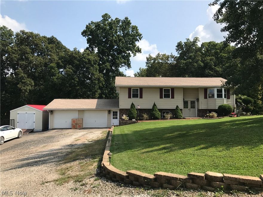 Look no further... the property you've been searching for is right here!! You will fall in love with this picturesque setting which offers 2.25 acres. Enjoy a completely move-in ready 4 bedroom, 2 bath home with almost 2,400 square feet. Upstairs features a nice living room with bay window, breakfast nook, beautiful kitchen with appliances, 3 bedrooms and 1 full bath. Downstairs you will find a large family room, full bath, master bedroom that walks out onto the patio, laundry room and plenty of storage. Lovely attached 2-stall garage, a heated and cooled 16x20 ft. storage building and an extra storage building for all your lawn supplies! Take in summer evenings on the newly refinished large deck. This property simply has too much to mention so come see it before it's SOLD!