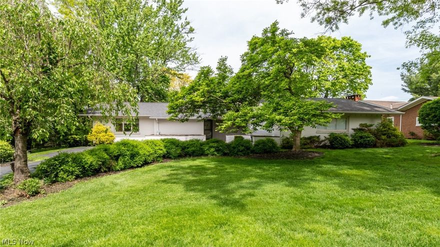 Super sharp, "Ryan" Ranch home in Beachwood for the best in one-floor living! Random plank hardwood in foyer opens to oversized living room with Cathedral beamed ceilings LR/DR with gas fireplace and sliders to the patio and raised deck! Spacious dining room in "L" shape has vaulted ceiling and offers great flow for entertaining. Eat-in kitchen with custom Cherry cabinetry, with hardwood floors, has center island, pantry and planning desk! Unbelievable 19x19 family room addition with vaulted beamed ceiling, built-in bookcases, and "air conditioning/heater." Wall of windows looking onto the private,  park like backyard!! Master bedroom has remodeled en-suite full bath with glassed in step-in stall shower  Two bedrooms in hall, one being used as an office, share full bath with shower over tub. Tons of storage throughout including both up and down crawl spaces. Amazingly spacious first floor laundry/utility off kitchen with access to two car garage. Newer (9 years) roof and furnace. Deck recently power washed and sealed. Newer concrete patio. Beachwood amenities include walking and dog trails, new Aquatic Park, near Sulgrave Oval and award winning Schools! Don't miss this one!