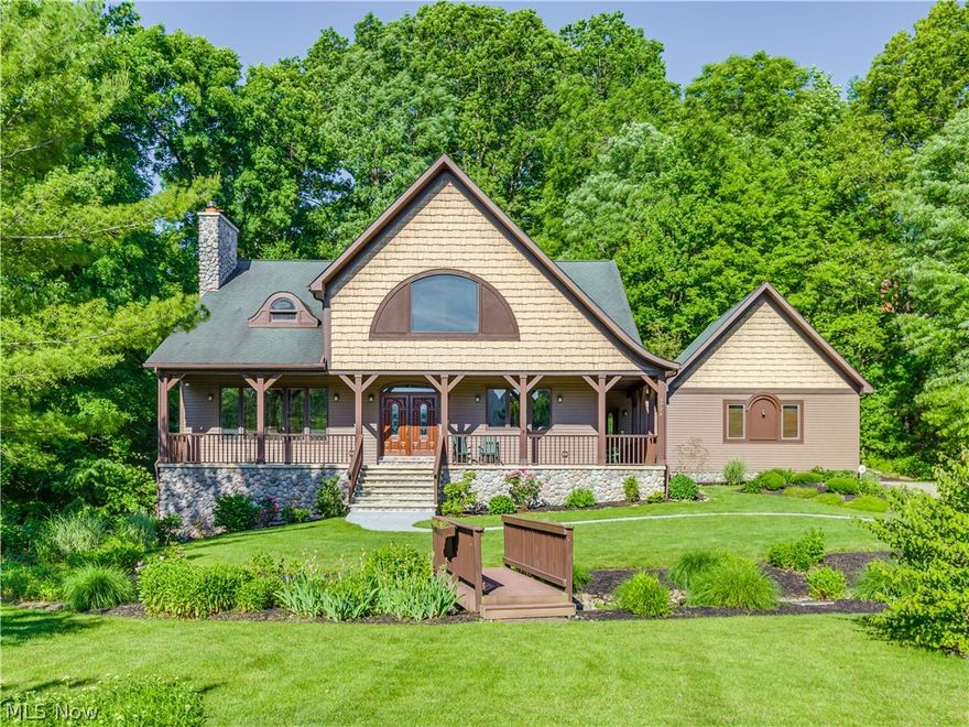 Magnificent custom built Cottage Style Cape in High Hampton! This premium lot overlooks a wooded area creating a completely private backyard. The curb appeal says "welcome home" with a wrap around porch overlooking the huge front yard and a bridge that crosses over a small brook which is filled with lily pads and goldfish. The main gathering area is the 30 x 19 Great Room with a cathedral beamed ceiling, full wall stone gas  fireplace and gleaming hardwood floors that continue through out the first floor. The spacious kitchen is bright and cheery, it includes the dining area and is tastefully accentuated by stained glass light fixtures. It also has 2 bay windows bringing in the natural light, a breakfast bar, 2 full ovens, a jennaire stove top & access to the 30 x 15 deck porch. The master suite is on the first level with french doors to a brick patio. A second bedroom, full bath, and laundry rm complete the first floor. Upstairs you'll find two more spacious bedrooms and a full bath w