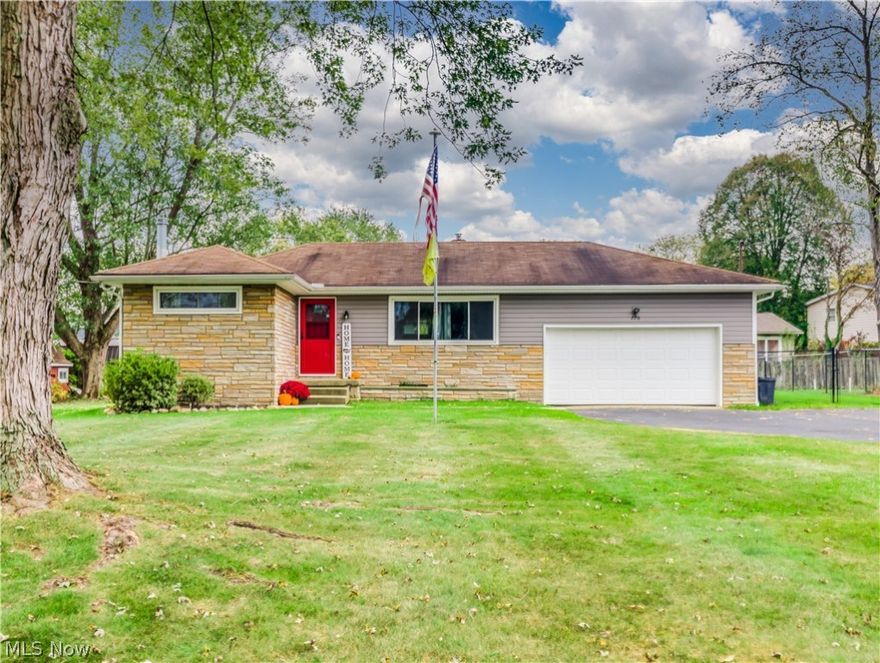 This sensational Tallmadge ranch offers a wonderful open floor plan that is enhanced by the expansive picture window that allows beams of sunlight to brighten your main living area. Painted in a palette of inviting grey tones, there is nothing to do but move in and enjoy. You will appreciate that both full baths, kitchen and rec room have been renovated. Also add windows, siding, central air, storm doors, Pergo plus flooring throughout, and lower-level carpeting to the list of recent improvements. The wood burning stove in the Rec room is perfect for staying toasty during the frosty winter nights. The exterior boasts an attached 2 car garage and spacious fully fenced yard.  Located with-in walking distance of beautiful Maca Park and just minutes away from the Tallmadge Recreation Center, 770 Beechwood Dr. is the perfect choice for your next home. Call for your private showing today!
