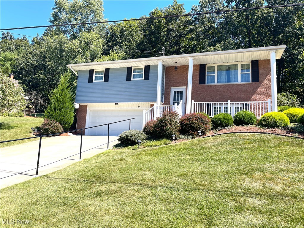Welcome to this classic bi-level brick and vinyl home, offering 3 bedrooms and 1.5 baths in a well-established neighborhood. Beautiful landscaping enhances the curb appeal, while inside you'll find a thoughtfully maintained home with light oak kitchen cabinetry, modern updates, and warm neutral tones throughout. The full bath features a sleek walk-in shower with a glass door and matte black fixtures, and fresh carpeting adds comfort across the living areas. The lower level expands the living space with a family room perfect for gatherings, a versatile bonus room ideal for a home office or hobby space, and a large laundry area with a convenient half bath. A newer roof and heating system simply add to the value of this move-in ready home. A clean, attached two-stall garage completes the home, blending comfort, function, and timeless style.