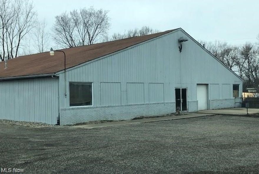 1.12 acres zoned commercial with a 6,800 square foot building. Located on the third busiest road in town with 10,000 cars per day. Some features include 24'x24' room with 5' high receiving door. Utility room with sink, water tank & furnace. 32 x24 medium temp cooler with condensers and compressor in good working condition with 1/2 bath restroom attached. 32x32 room with new 12'wide x24 high door at grade level with new electric opener. Front room is 44'x48' plus 3 office rooms - one 8'x10 & 2 8'x12'. Dock level receiving area with 3 bay landing. Electric door 8'x8' opening to unloading dock. Roof replaced in 2005. Exterior recently painted. 10' floor slab. 3 phase 208 voltage electric.