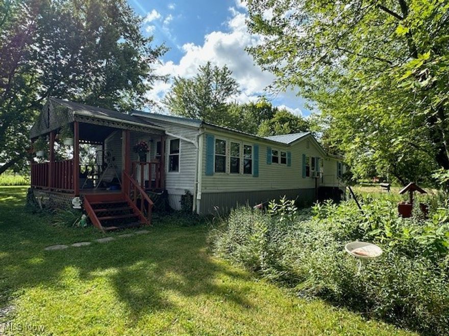 Come see this home is the country on 1.27 acres!! This 1992 Mansion built mobile home offers 3 bedrooms, 2 baths, 2 car detached garage, covered deck, large living room! Plenty of space for gardens!! Come check it out at this affordable price. Owner is selling AS IS. Furnace is newer and septic was cleaned in 2020 by G&J. Survey was updated 2017.