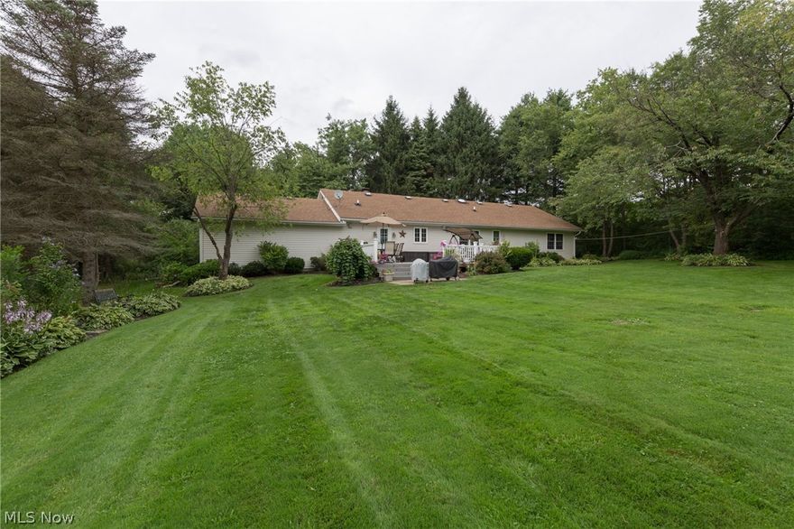 Welcome Home! Turn the Key and Move Right In! This Well Maintained and Spacious Contemporary Ranch Sitting on a Little Over 1.5 Acres is Waiting For You To Call Home! 3 Bedrooms, 3 Bathrooms, 1800 sq ft of Living Space on 1st Level, and an Open Floor Plan! Living Room w/ Wood Burning Fireplace has Vaulted Ceilings Filling Room w/ Natural Light. Spacious Kitchen w/ Plenty of Countertop Space & Storage Flows Seamlessly to Living Room & Formal Dining Area! Master Suite Provides Tastefully Updated Full Bathroom w/ Walk-In Closet! Bamboo Flooring Flows in Hallway and All Bedrooms! Sliders Off Dining Room Lead to Treks Deck Overlooking Huge Backyard! Large Utility Room w/ Ceramic Tile & Pantry on 1st Level! Finished Basement is Perfect Man Cave to Watch the Game, or Play Room for the Kids! Sitting Far off Mayfield Road w/ Pond in Front Yard! Other Recent Updates Include: Newer Windows, Flooring, Glass Block Windows, Electric Box, and So Much More! Call to Schedule Your Viewing Today!