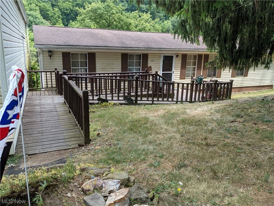 Must see !! Well-kept Home with 13.98 acres.  Large wood ramp or stairs leading to home.  Single car garage detached. Country living within walking distance to town with PUBLIC WATER & SEWER!   Nice 3 BR, 2 bath split ranch/modular with master bedroom and bath on one end & w bedrooms and full bath on other. 
Great sunroom with vaulted ceiling and beautifull backyard view.  24X24 Pole bldg with cement floor & electric but needs roof.  Could easily be used as equipment storage, horse barn, etc.  Rear acreage has vehicle access provided by easement from Boory Place.  Can be accessed on foot from home.  Mineral right owned but leased & seller received small royalty.