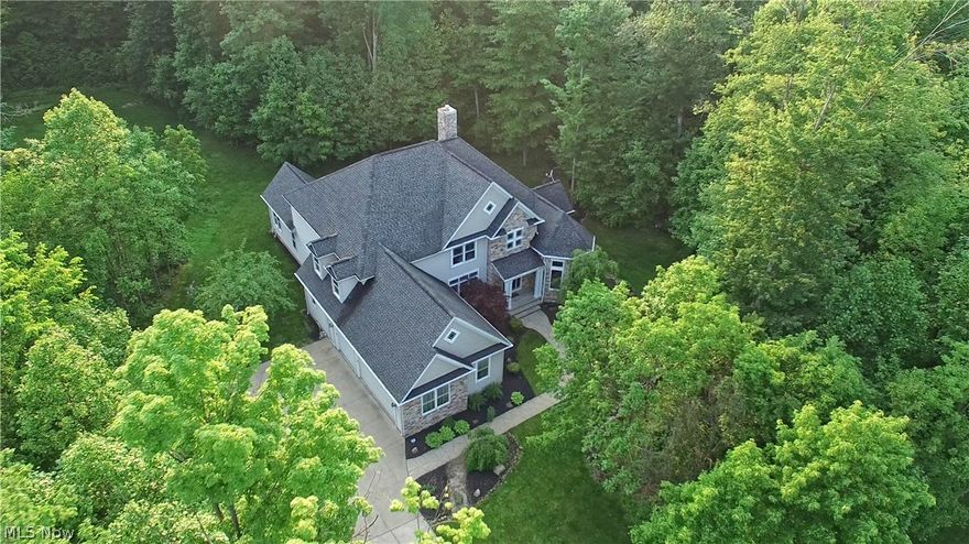 The life you deserve! 5 bedroom 4 ½ bath custom built home designed for luxury living in Auburn Township. As you walk into the front door you will enjoy the two-story foyer that features a beautiful bridge staircase. A two-story formal living room with built-in cabinetry and stone surround fireplace sets the stage as you entertain in the beautiful formal dining room. All of this flows to the open chef's dream kitchen. It features a massive center island with two sinks, stainless steel appliances, granite counter tops, and a JennAir cook top. There is also a private office, a mud room area combined with a large laundry room. Enjoy a private wing of the house with your own first floor Master Suite and luxurious private spa, complete with pillars and vaulted ceilings. As you enter, you’ll find your own spa retreat where you will enjoy soaking in your 2-person jacuzzi tub while watching your favorite TV show and sipping on your favorite beverage from the built-in refrigerator and enjoy the