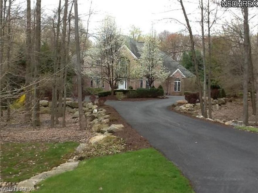 Stately yet comfortable,All Brick Colonial w/over sized heated 4 car garage Just over 4.5 Private Acres on a manicured lot with Circular Drive*4 Bedrooms each with on suite bath*Formal Living & Dining Rooms with Gorgeous Hardwood Floors*Split Staircase greets you w/2 Story Foyer*Gourmet Granite Kitchen w/Stainless Appliances, Center Island with eating area, Pantry, Vaulted Morning Room & concealed 2nd Laundry*2 story Great room w/Fireplace & built-ins*Open Walkway to Upper level Bedrooms w/stunning views of Great Room,Foyer,Back Yard*1st floor Vaulted Master Suite w/Brazilian Cherry Floors w/Private Vaulted Sitting Area/Office/Study &access to Deck *Vaulted Private Glamour Bath His/Hers Sinks/Twin Walk-in Closets* Spacious Loft*Upper Level Large Main Laundry Room.Finished Walkout Lower Level w/Large Wet Bar 2nd F/P,Full Bath,Workout Rm/game rm.Maint Free Super sized Deck with Electronic Awning*Award Winning Schools*See it again for the 1st time and note the nuances