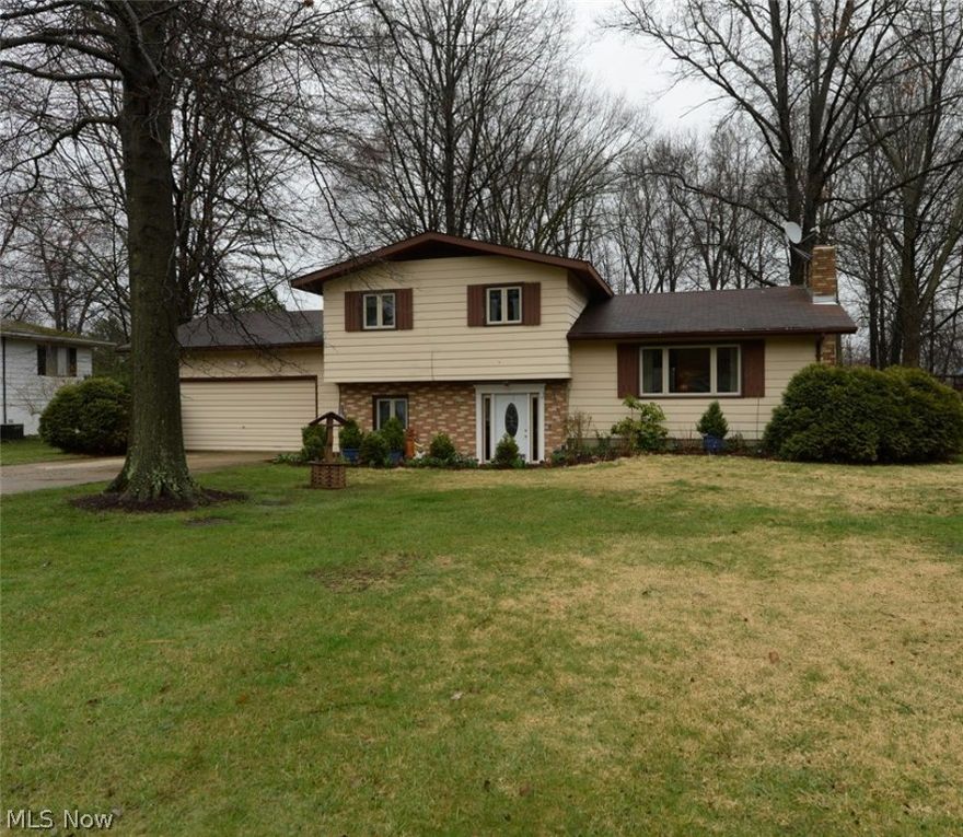 Remarkably maintained split level home in Norton!  Walk into the oversized family room with a nice entryway and large coat closet.  This beautiful bright room has a brick accent wall, new carpet, recessed lighting and washer and dryer hook ups. Off of the family room there is garage access and a full bath.  Walk up to the main level into the vaulted living room with a working fireplace featuring travertine and mosaic tile.  The dining room has sliding glass doors that open out onto the deck.  The spacious kitchen has lots of gorgeous oak cabinets, laminate counter tops and a ceramic tile floor.  On the third level you will find the second full bath, the master and 2 additional bedrooms.  The master bedroom has large closets and sliding glass doors out into a private balcony!  There is carpet all throughout the home with hardwood floors underneath.  New windows 2 years, newer sliding doors.  In the basement there is another washer/dryer hookup, EZ Breathe humidifier, water softener, sum
