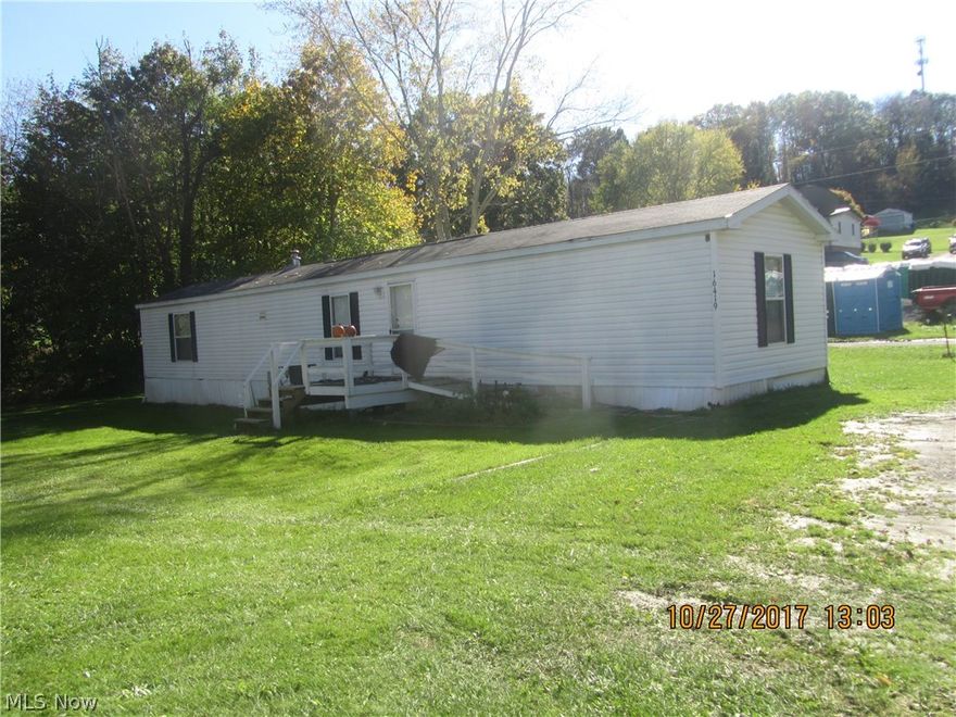 Newer floor coverings throughout this 3 BR 2 BA mobile home on 3/4ths of an acre, corner lot.  Front and rear decks, detached garage and storage shed. Plenty of room for a second mobile home on this lot, community water and sewer with a second sewer tap near the garage.  Month to month tenant who is willing to stay if wanted.  Convenient to all Calcutta amenities.  3 lots totaling 3/4ths of an acre level lot. Newer electrical, and newer sewage lines to street with State approval of mobile home set up.