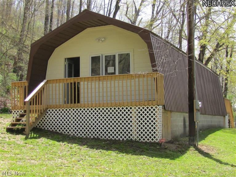 River access. Property is being offered as is unfinished. 5+ acres on Bucklew Run, 419' creek frontage, at the junction of the Killbuck and Walhonding river. Up grades include metal roof, cement siding, windows, doors, decks, electric to house. Well and Septic are disconnected during remodel but functioned when purchased.Spring on hillside. Possible hillside home site.