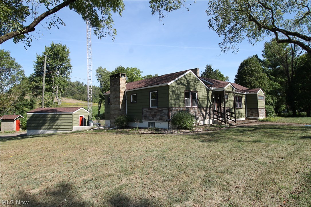 Seller willing to contribute towards buyers closing costs. Beautifully updated Ranch home on two lush acres of land with a pond. This wonderful home offers three bedrooms on the main floor with gorgeous hardwood floors and two full baths and one half. Updated, spacious open eat in kitchen with plenty of storage and cooking surfaces for entertaining, beautiful backsplash, and ceramic flooring. Also a small bar area with plenty of room for some bar stools. Bright, open great room offers a nice cozy fireplace for those cold fall evenings, and on the lower level you will find the family room. There is a large outbuilding with loft plus shed. Outside fireplace with covered patio and large deck and pond. Finished basement with bathroom and office space. Barn has its own additional power. Storage shed or work shop on 2nd level of barn which can be finished or for storage. Smoke house on other side of drive is included.