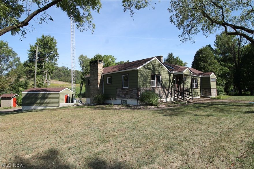 Seller willing to contribute towards buyers closing costs. Beautifully updated Ranch home on two lush acres of land with a pond. This wonderful home offers three bedrooms on the main floor with gorgeous hardwood floors and two full baths and one half.  Updated, spacious open eat in kitchen with plenty of storage and cooking surfaces for entertaining, beautiful backsplash, and ceramic flooring. Also a small bar area with plenty of room for some bar stools. Bright, open great room offers a nice cozy fireplace for those cold fall evenings, and on the lower level you will find the family room.  There is a large outbuilding with loft plus shed.  Outside fireplace with covered patio and large deck and pond.  Finished basement with bathroom and office space.  Barn has its own additional power.  Storage shed or work shop on 2nd level of barn which can be finished or for storage. Smoke house on other side of drive is included.