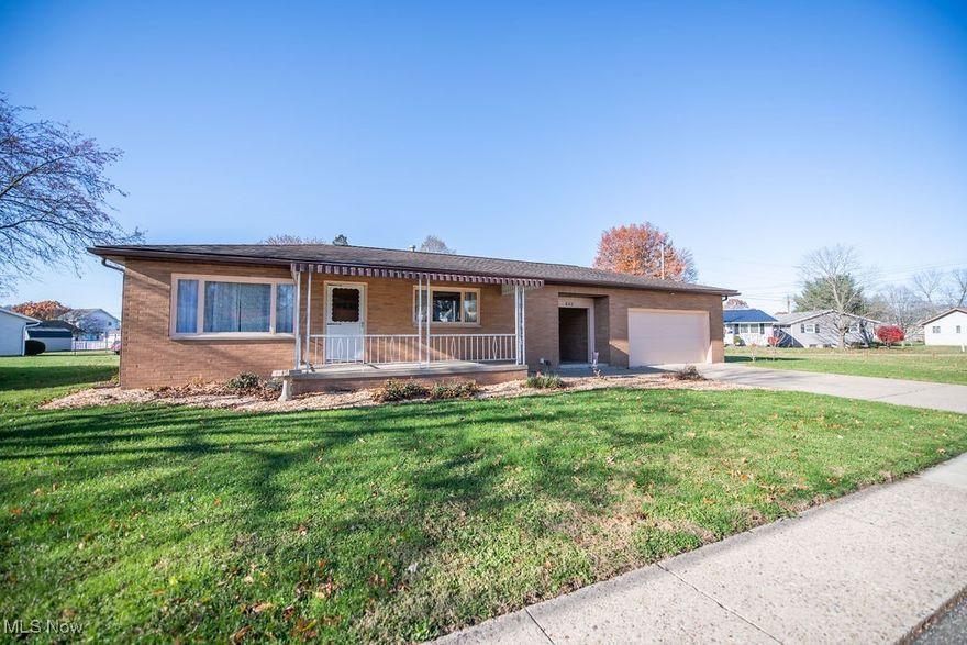 Presenting a mid-century ranch property in a desired New Phila location. This maintained, all-brick home offers two bedrooms and two bathrooms. The original hardwood floors have been refinished, and new, matching wood floors have been installed in the kitchen and bath. The eat-in kitchen features a new butcher block countertop and freshly painted cabinets. The full basement downstairs includes tile floors, an additional bathroom, and the laundry room. A breezeway connects the kitchen to the attached two-car garage, and the property offers a vinyl fenced-in backyard.  This home is conveniently situated on a corner lot and is near shopping centers, schools, and parks.