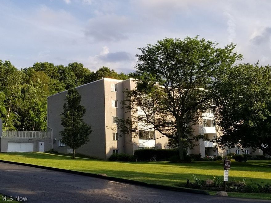 Pristine ground floor condo at Whispering Heights, minutes away from Portage Crossing! This is the most desired place to enjoy maintenance free living in Cuyahoga Falls. Almost everything you need is provided in the monthly condo fee. This includes unlimited water, gas, electric, basic cable TV, trash removal, landscaping and snow removal. Free amenities include; a swimming pool, workout room, hobby room complete with a pool table and library, a beautiful common area with brick fireplace, public laundry facility, a personal locked storage area and a party/meeting room. This super-safe complex is nestled on a wooded hillside in one of Cuyahoga Falls nicest neighborhoods. The layout has a huge open living room and dining room. The eat-in kitchen is light, bright and ample, and you’ll appreciate the fresh, neutral paint and new carpet throughout. The large Master bedroom connects to a spacious closet, with the full bathroom nearby. The condo features a year round enclosed sunroom that can