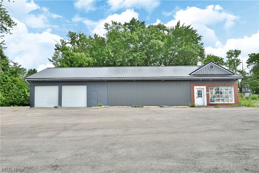 Don’t miss your chance at this fantastic opportunity, located on an advantageous, high-traffic location in the up-and-coming downtown Warren area. With revitalization projects in full swing, this substantial property with its long running office and garage/warehouse space is in a prime position to take advantage of future growth. Once configured as an automotive shop, the stylish gray building has been converted into an open office and garage/warehouse space, still keeping its window lined lobby, complete with brick accent work and additional pent roof. Industrial grade lighting can be found throughout with concrete floors underneath. Overhead heating is ducted neatly over the potential shop bays or office area as needed. Multiple secure entryways allow for four-sided access and past garage lift assemblies remain in place. The garage/warehouse is 31' x 27' and offers two new 9' x 11' garage doors. An additional bonus room allows for an employee lunchroom and additional storage along wi