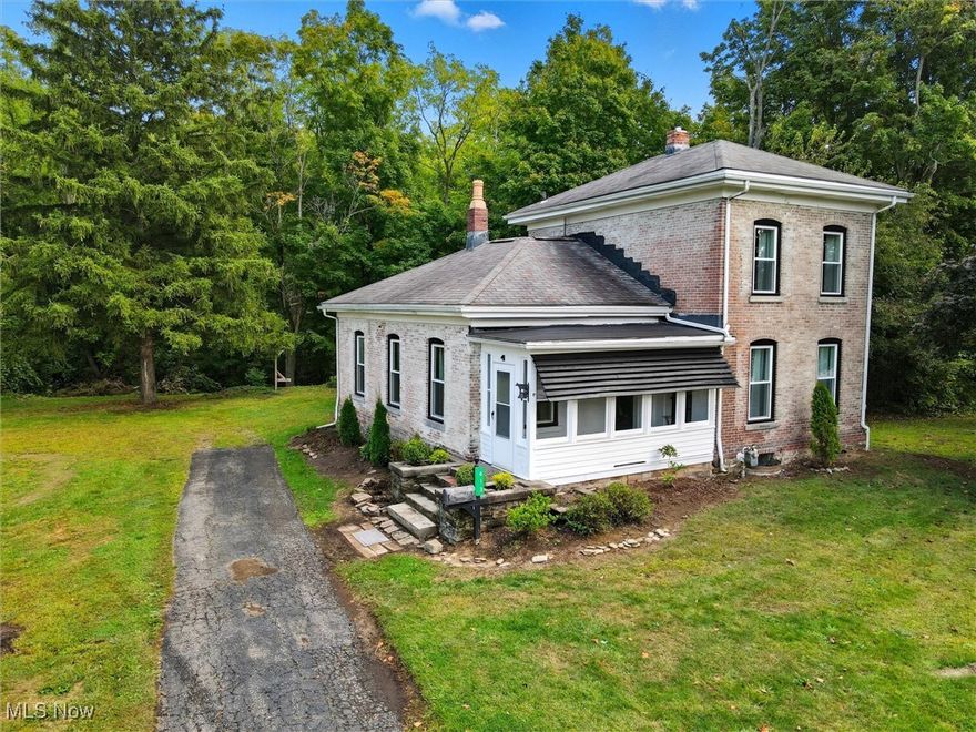 This beautifully updated brick colonial sits on nearly 0.70 acres with a peaceful creek at the back and plenty of room to add a large garage if desired. The home has been tastefully remodeled throughout, blending modern updates with timeless character.

Step into the stunning new kitchen, featuring quartz countertops,  pantry, brand-new appliances, wood ceilings, and abundant counter space with room for a table. The first floor offers a bedroom with original hardwood floors, as well as a spacious room with vaulted wood ceilings, natural hardwood floors, and a gorgeous gas fireplace with mantel—perfect as a living or dining room. Enjoy quiet mornings in the sunporch or gather in the inviting step-down family room, highlighted by exposed brick walls that create a cozy, character-filled atmosphere ideal for winter nights by the Christmas tree.

The home includes a fully renovated first-floor bath with double sinks and a tiled tub, plus a convenient brand-new half bath off the family room. Upstairs, you’ll find two additional bedrooms and a hall closet designed to accommodate a stackable washer and dryer. Modern updates throughout include all-new windows, updated plumbing, and a new electrical panel. A detached 2-car garage adds even more convenience for storage. 

Located just minutes from Geneva-on-the-Lake, over 30 local wineries, and the shores of beautiful Lake Erie, this home offers the perfect blend of privacy, charm, and convenience.