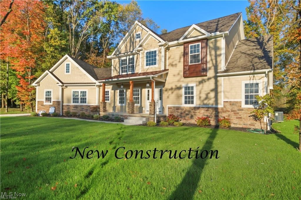 Craftsman inspired home with a front yard