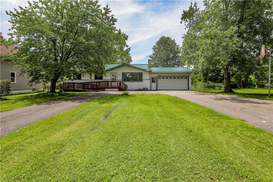 Wonderful investment opportunity presents itself with this 3 bedroom 2.5 bath Ranch style home and 5 pad Mobile Home Park in Ravenna Township. The well-maintained single family home features an inviting living room with hardwood floors, an eat in kitchen with designated dining area, and a full, partially finished walk out basement with: rec room, wet bar, full bath, workshop and laundry area. Additionally there is an attached two car garage and a handicap accessible ramp to the front door. The fully occupied five pad mobile home park with private sewage/wastewater plant provides a nice monthly income from the lot rent. Zoning is CR. Schedule your private showing to see everything this unique property has to offer! MOTIVATED SELLER!