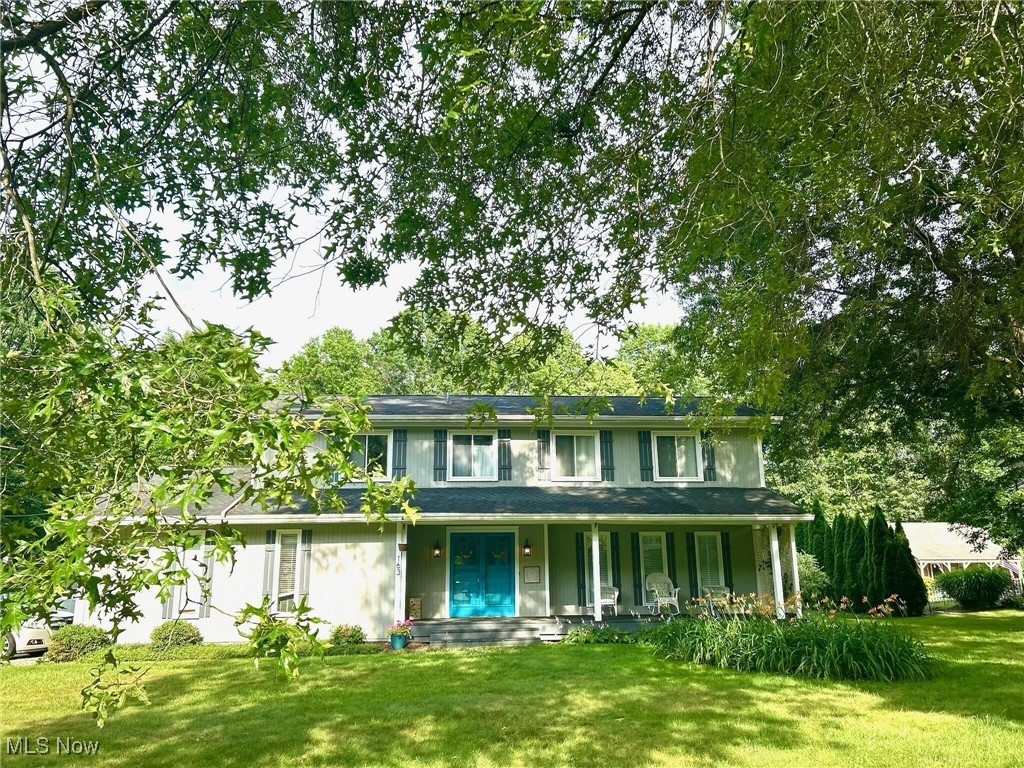 Welcome to this spectacular 4-bedroom Colonial located in the highly sought-after Revere School District! The current owners have thoughtfully brought this home into the 2020s with stylish modern updates throughout. Inside, you’ll find updated bathroom lighting, artfully selected paint in the upstairs bedrooms and bathrooms, and green guard certified luxury vinyl tile in the second floor bedrooms and the basement, creating a fresh and cohesive feel. The Living Room, Formal Dining Room, and spacious Family Room all feature hardwood flooring. The Family Room also offers a gas log fireplace and access to the deck through sliding doors—perfect for indoor-outdoor living. The primary suite boasts cathedral ceilings, a walk-in closet, and a beautifully renovated bath. A large finished room in the basement offers versatility as a home office, playroom or 5th bedroom. There’s also a partially finished recreation room in the basement that can be used as a workout room, workspace. Both add charm and functionality. Additional features include updated 150 AMP electrical service, glass block windows, and city water. The exterior is equally impressive with adorable teal double front doors, raised vegetable gardens, a brick fire pit, lush landscaping, and a generous ½ acre corner lot—ideal for relaxing, entertaining, and grilling. Lovingly maintained with care, dedication, and attention to detail, this home is move-in ready and full of character. Green