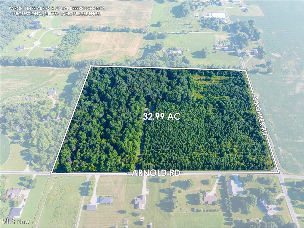 Discover 32.99 acres of scenic, multi-use land in a prime Wayne County location—ideally situated between Kidron and Orrville at the corner of Arnold Rd. and Kohler Rd. With excellent road frontage and easy access, this property offers a rare combination of visibility, privacy, and versatility. It is enrolled in an agricultural conservation easement, which requires it to remain a single parcel, but includes a homesite exemption allowing for approximately 2 acres to be used for your homestead. The land features around 15 acres of mature, harvestable timber, with the remaining acreage planted in 2005 with over 11,000 native hardwoods. A well-maintained trail system weaves through the property, making it perfect for hiking, horseback riding, or ATV use. Combined with excellent hunting opportunities, this property offers strong recreational appeal alongside its agricultural value. Infrastructure includes an established driveway and private water well, plus a developed camping and recreation area complete with a pavilion, picnic shelter, storage barn, small horse barn, swing set, volleyball area, and a concrete pad for basketball or other activities. Mineral rights will transfer and appear to be open. Seller financing is also available, creating added flexibility for buyers. Whether you're looking for a private retreat, a future homestead, or land with investment and recreational potential, this property delivers.