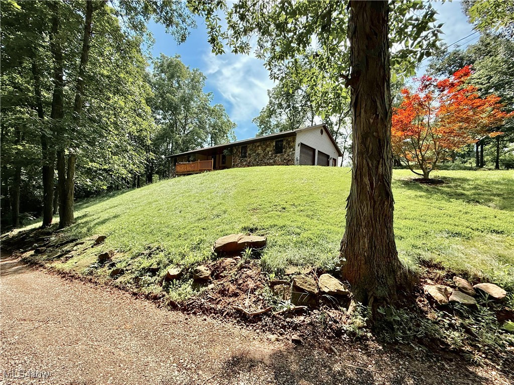 28 Bell Road starts with the drive home. The scenic driveway winds gently through 3.68 acres of land, trees swaying in the breeze, a sense of calm settling in before you even reach the front door. You’ve made it, your own slice of country paradise, tucked away in the Warren Local School District. The ranch-style home greets you with comfort and space. Vaulted ceilings and natural light make every room feel open and welcoming. With 3 bedrooms and 2 full baths, there’s room for everyone, and the main-level laundry makes daily life that much easier. The oversized double garage holds more than just cars, there’s space for tools, storage, or even your next project. And then there’s the basement...a massive space with 9-foot ceilings that stretches on and on. It’s the kind of place you can get lost in, full of potential, ready to be transformed into anything you imagine. Outside, life slows down. You can have chickens clucking in the coop, goats grazing lazily in the pasture, and gardens bursting with color and produce. This isn’t just a home—it’s a homestead. A mini-farm. You’ll spend lazy afternoons deciding which deck to relax on, each offering its own view of the land and the sights and sounds that come with it. It feels like the middle of nowhere, yet you're still close to everything. Don’t wait. Call now and call it HOME.