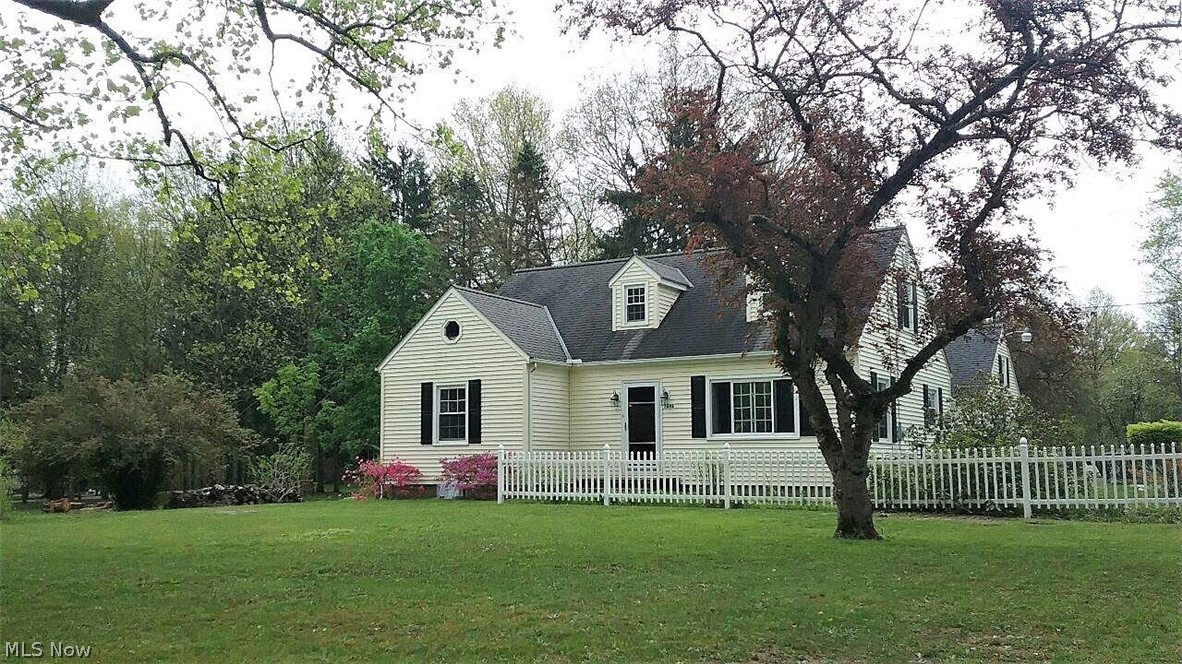 Come home to comfort in this charming four bedroom, one full bath cape cod with adorable little white picket fence. The family room offers large windows to let the natural light to shine through and is open to the dining room and kitchen area. The bright remodeled kitchen has granite counters (2019), plenty of cabinet space, ceiling fan, hardwood floor and a window above the sink for more sunshine. The master suite and another bedroom offers hardwood floors and there is a bright full bathroom all on the first floor. Upstairs offers two more bedrooms, the fourth bedroom is not finished, but all the wood and materials are included to finish the center area. The lower level offers a walk out basement with a fireplace and mantle, an extra shower and sink. There is a covered back patio to enjoy even on those rainy days. The large backyard offers plenty of space for all your entertaining needs. There are three sheds. Two car detached garage with garage door openers. Some new updates include