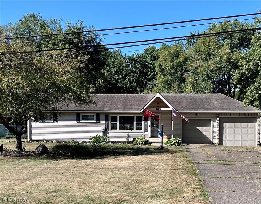 Welcome to 5221 Revere Ave. N. E. Massillon, OH!   Don't let the size fool you from the outside. It you're looking to downsize or for your first home, don't miss this one!  A charming and beautifully maintained ranch. Enjoy the updates throughout, including fresh paint, new PERGO flooring, and updated baseboards (2025),  giving the home a modern and move-in-feel. This home features a spacious master bedroom with dual closets, a second bedroom, and a full bathroom. with a convenient laundry chute. The inviting living room flows into the kitchen, making it perfect for everyday living. The kitchen sliding doors open to a  spacious deck, 15 X 16 and a covered patio, that opens to a large a fully fenced backyard. The finished basement 11 x 37  offers endless possibilities for a family room, home office, or entertainment space. There are two garages one conveniently off the kitchen and the other ideal as a workshop or additioal storage.