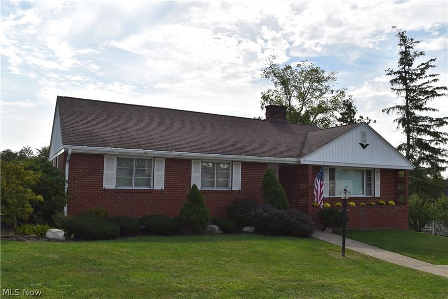 Beautiful brick one story home with a nice fenced back yard and covered rear deck to relax on. This home has so much curb appeal with lovely landscaping that surrounds the house. This home is located an outstanding subdivision. The home offers 3 bedrooms, 1.5 baths with them both being totally remodeled and newer plumbing per owner, a large eat-in kitchen with Corian style countertops, a huge living room with a wood burning fireplace, and a nice basement rec room with a gas log fireplace. Replacement shingles in 2011 with 30 year shingles and the hot water tank was replaced in July 2021. There is also a 2 car tandem garage and a large paved driveway to park several cars.