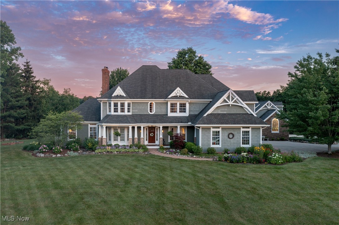 Welcome to this exceptional property in Hudson's Canterbury Lakes! With the vintage whimsy of an arts and crafts colonial and all of the conveniences for modern life, this one-of-a-kind property brims with curb appeal and charm. Sitting on a serene 1.2 acres, the yard is a perfect oasis with carefully-tended garden beds and stunning views. Throughout the home, thoughtful and charming details delight and inspire, including custom stained glass, crown molding, tin ceilings, fireplaces, and antique lights and hardware. The custom kitchen was renovated in 2021 with flush mount cabinets, variegated granite and quartz countertops, reclaimed subway tile backsplash, and solid brass Eastlake antique hardware. At the back of the house, an expansive first floor wing was constructed in 2019. The wing includes a large living area, deck access, a gorgeous sunroom, two flex rooms, and a stunning full bathroom with an oversized marble shower and a soaking tub. Stunning details of the addition include quarter sawn white oak flooring with walnut and mahogany medallions, antique interior doors, and custom cut-glass fixtures. A separate entrance and dedicated 2-car attached garage make the addition a perfect in-law or guest suite. The garage is fully equipped as a dream workshop with 40 amp service, numerous 220 volt outlets, 250 lb capacity overhead winch, a Reznor commercial gas heater, and a second-story studio space. Four bedrooms and two full bathrooms can be found on the second floor. The lower level has endless options to be finished into a home fitness center, playroom, or media area. Enjoy low maintenance synthetic decking and the screened in gazebo, all overlooking a peaceful pasture and pond beyond the fence. From the walkway lined with perennial gardens to the pergola and brick path, every inch of the property has been meticulously cultivated for serenity.