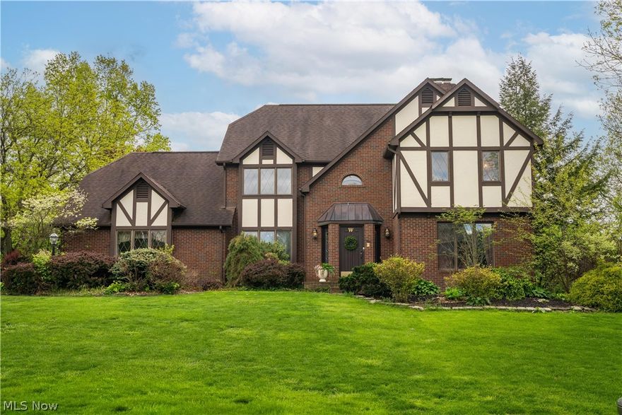 Stately Tudor-inspired brick home situated on a beautifully landscaped lot with timeless curb appeal in desirable Foxchase Hills. Featuring distinctive architectural details including steeply pitched rooflines, decorative half-timber accents, and classic  diamond paned windows, this residence offers a warm blend of character and sophistication. Upon entry of the home you are immediately greeted by the open, turned staircase and 15 ft ceilings. Oak hardwood floors flow through the first level and complement the cherry crown molding that's found throughout the main areas of the home. The front living room has recently been updated with new carpet and paint. The hallways, dining room and 4th  bedroom/office and kitchen have also been repainted. The open kitchen is warm and inviting with cherry cabinetry, Cambria quartz counters, new lighting, new cabinet hardware and Stainless steel appliances. Off of the kitchen a passthrough bar connects to the great room featuring a sloped 19 ft ceiling with sky light and stone floor to ceiling fireplace. Upstairs are 3 well situated bedrooms with walk- in closets. Off the 3rd bedroom is an additional large storage closet for extra household needs. The 2nd full bathroom is a split design featuring the shower area and vanity separate from the water closet and another vanity. The master has a classic cherry wood style gas fireplace and spacious ensuite with pitched ceiling and skylights, double sinks with new faucets and vanity lighting, shower and separate jetted soaking tub and was recently freshly painted. Downstairs the basement is fully finished with 2 rec areas and features a pool table that stays and a kitchenette/bar area with granite counters. Outside is more room for entertaining with a 2 tier trex deck, gazebo and koi pond with a waterfall and patio area. This home is truly one of a kind and ready for it's new owners! Agent owned.
