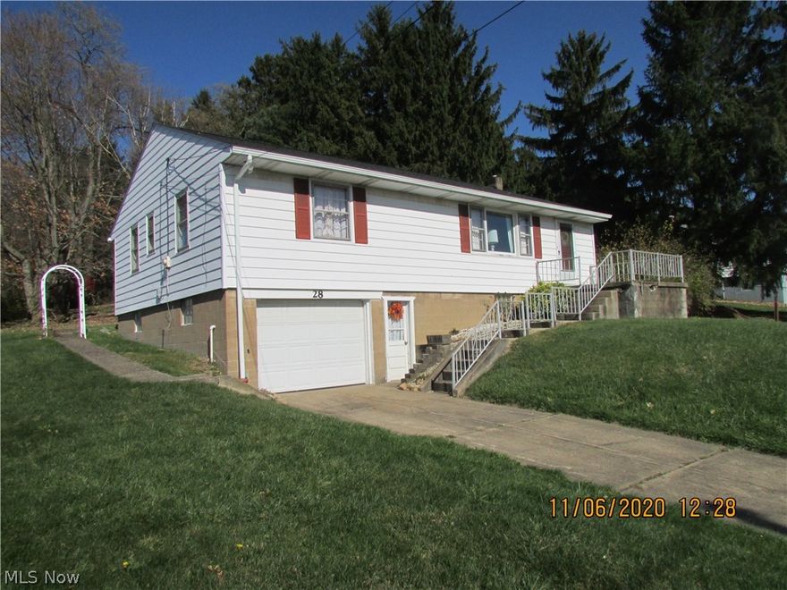 Attic and side walls were insulated in 1970's.  Attic has flooring for storage.  Hardwood floors under carpet in Living Room and 3 Bedrooms.  Paw-Paw trees bear fruit.  Garage door opener.  Septic has passed county inspection.