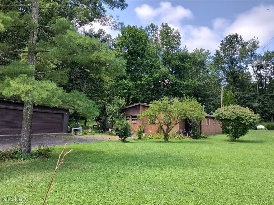 Location and Opportunity.  This home is beautifully situated on a quiet Township Road in a small development (Mitchell Addition).  Two+/- beautiful acres featuring a pond, mid-size hobby barn perfect for horses, chickens, goats. Two detached garages.  One 24x32 and the other 18x18.  The home features three bedrooms, and two baths, a large open living room, dining room, and kitchen.  Just off of the living room is a screened porch overlooking a small creek and private backyard.  This is a must see.  There is no working   central heating system; but there is Central Air.  Propane heater and wood burner.   The home is being sold AS IS.  Cash or Conventional.  Great opportunity for someone ready to do some work to make this their forever home.
