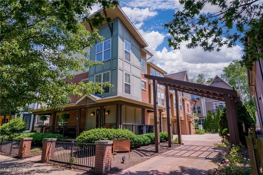 Nestled on Ohio City's most desirable block lined by old-growth trees, new construction, and well-maintained century homes, you’ll absolutely love coming home! This 2 bed, 2.5 bath "entertainers" townhouse features a newly renovated chef's kitchen, new LVP flooring, dual owner's suites, two lofts, and three outdoor living spaces! Relax in the shade and enjoy the picturesque streetscape from your wraparound front porch. Around the corner (also accessed through the garage) is a privacy-fenced side yard w a patio and a convenient dog run for your pooch to safely roam leash-free. Enter to a spacious foyer w a coat closet, large storage closet, and a bedroom w a walk-in closet and ensuite bathroom w a tiled walk-in shower. With vast open spaces and abundant natural light, the main floor is designed to impress. The spacious great room showcases soaring vaulted ceilings, 2-story windows, a contemporary gas fireplace, and a cozy reading/desk nook. Newly renovated and redesigned, the massive luxury gourmet kitchen is an absolute dream for hosts and home chefs, boasting storage and quartz countertops galore, an island w breakfast bar, high-quality cabinetry (soft-close, dovetailed), double wall ovens, a dining area, coffee bar, and a large butler's pantry w a wet bar and wine fridge. Down the hall is a half bath, laundry closet, and your privacy-fenced composite deck for grilling and alfresco dining. Upstairs is a large bedroom w two closets, a hall bathroom w a tile-surround soaking tub, and two lofts. The front loft space is large enough for two desks to work from home. With two closets, the larger loft area has myriad possibilities as a game room, second living space, exercise area, or easily walled off as a third bedroom. Newer AC & hot water heater. Enviable Hingetown neighborhood location, walk/bike to Edgewater Park, fitness centers, West Side Market, convenience stores, cafes, and countless bars/restaurants. Only 1.5 miles to downtown CLE!